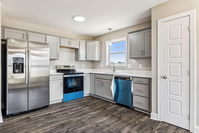 kitchen featuring a sink, stainless steel appliances, gray cabinetry, and light countertops