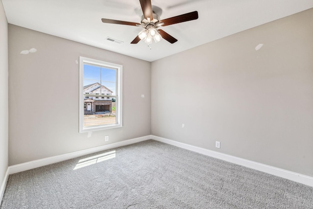 spare room with visible vents, ceiling fan, baseboards, and carpet