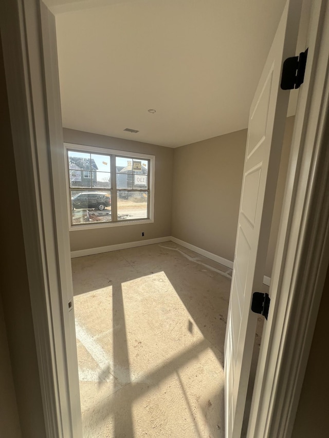 unfurnished room featuring visible vents and baseboards