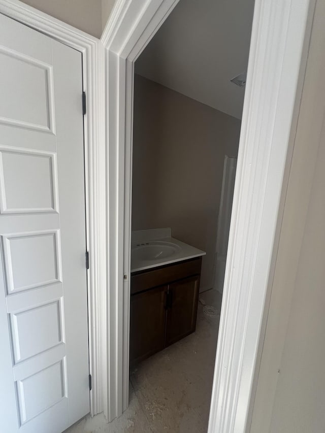 hallway featuring a sink and concrete flooring