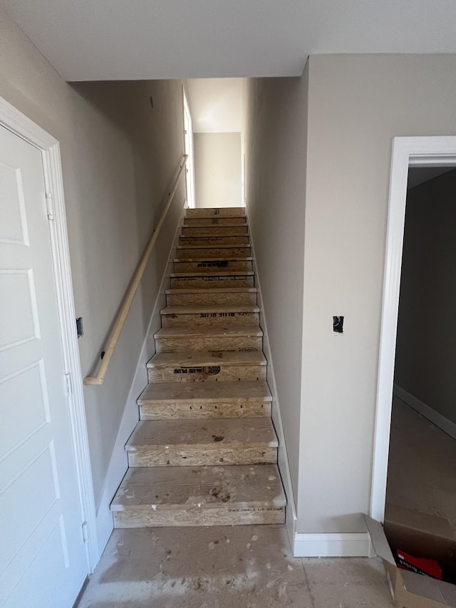 staircase featuring baseboards