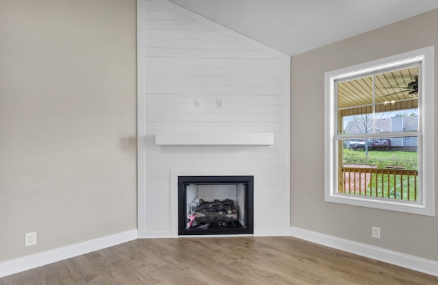 130 Anderson Pl, Clarksville, TN 37042 - unfurnished living room featuring a large fireplace, wood finished floors, and baseboards
