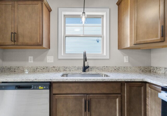 130 Anderson Pl, Clarksville, TN 37042 - kitchen featuring stainless steel dishwasher, a sink, light stone countertops, brown cabinetry, and hanging light fixtures