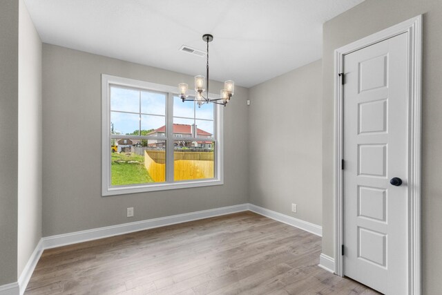 130 Anderson Pl, Clarksville, TN 37042 - unfurnished dining area featuring baseboards, visible vents, light wood-style floors, and a notable chandelier