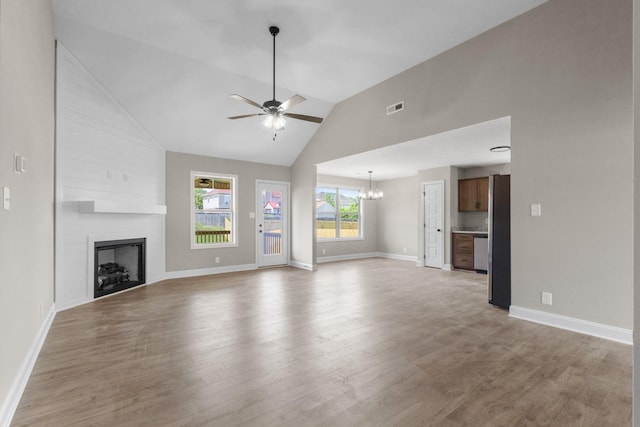 130 Anderson Pl, Clarksville, TN 37042 - unfurnished living room featuring ceiling fan with notable chandelier, light wood-type flooring, a fireplace, baseboards, and visible vents