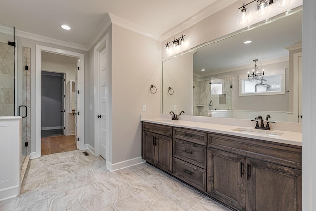 bathroom featuring a chandelier, vanity, a shower with shower door, and crown molding