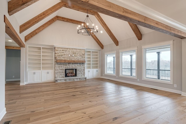 unfurnished living room with a stone fireplace, a wealth of natural light, beamed ceiling, and light wood-type flooring