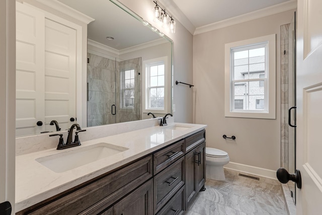 bathroom with vanity, toilet, a shower with door, and crown molding