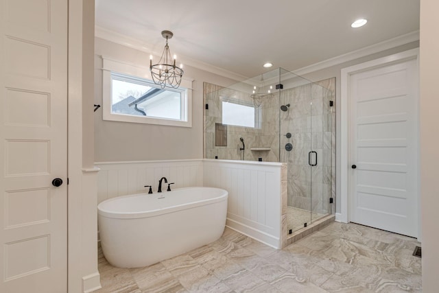 bathroom with separate shower and tub, ornamental molding, and a chandelier