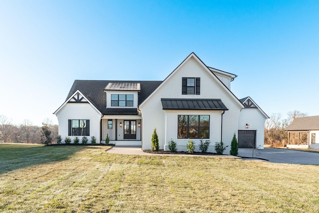 modern farmhouse with a porch, a garage, and a front lawn