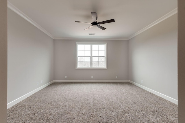 spare room featuring carpet, ceiling fan, and crown molding