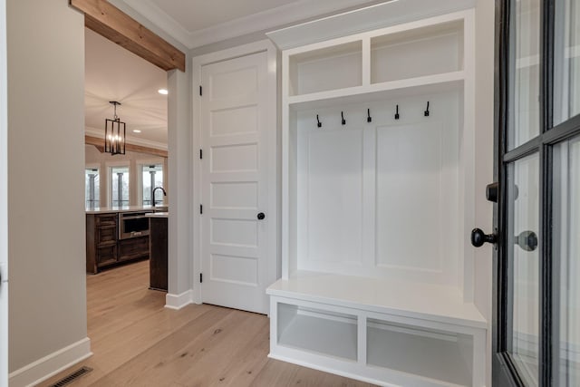 mudroom with a chandelier, light hardwood / wood-style flooring, crown molding, and sink