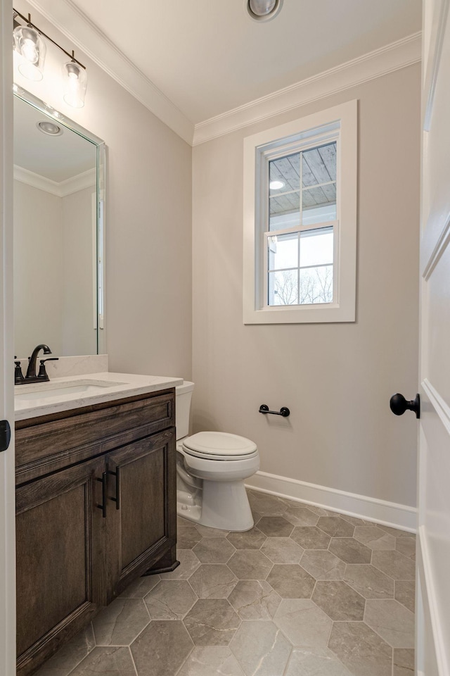 bathroom featuring vanity, toilet, and crown molding