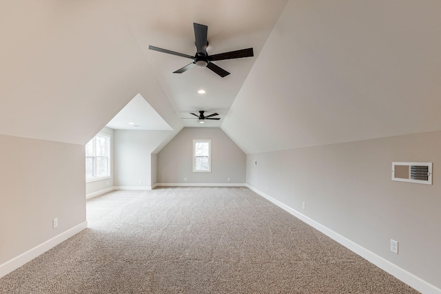 additional living space featuring carpet flooring, ceiling fan, and lofted ceiling