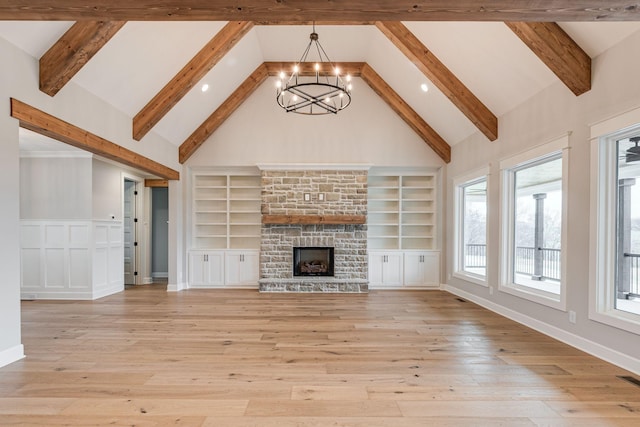 unfurnished living room with beamed ceiling, light hardwood / wood-style floors, high vaulted ceiling, and a notable chandelier