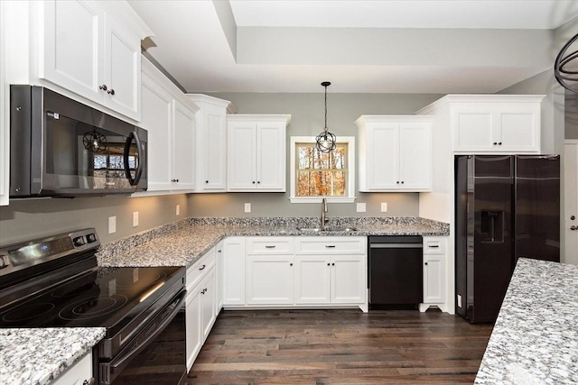 kitchen featuring light stone counters, dark wood-type flooring, sink, black appliances, and white cabinetry