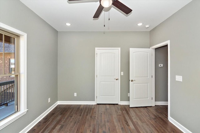 unfurnished bedroom with dark hardwood / wood-style floors and ceiling fan