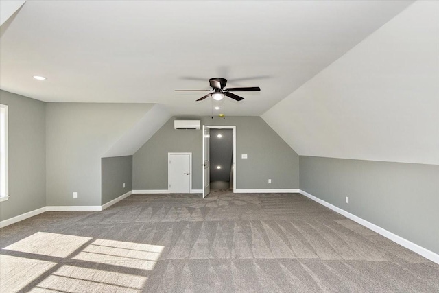 additional living space featuring a wall unit AC, ceiling fan, carpet flooring, and lofted ceiling