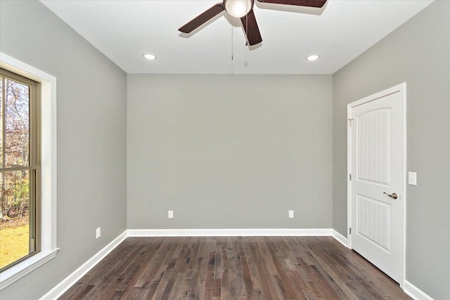 empty room featuring ceiling fan and dark hardwood / wood-style flooring