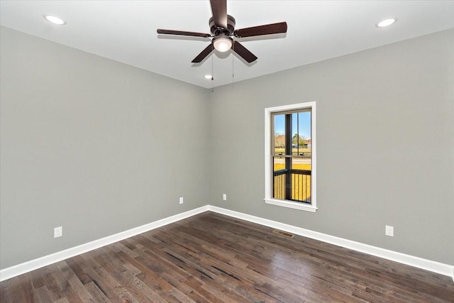 spare room with ceiling fan and dark wood-type flooring