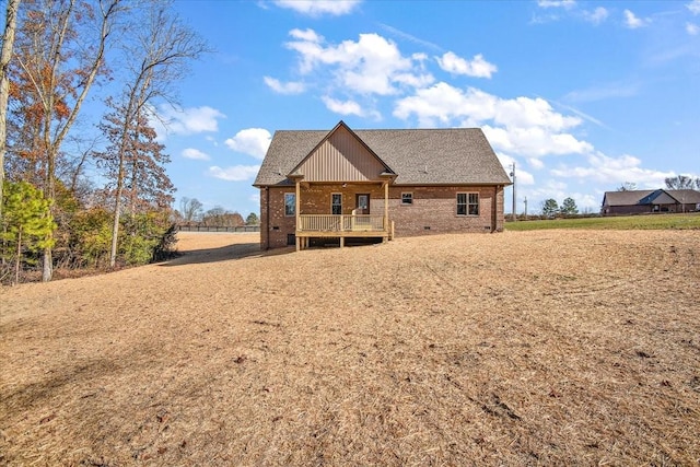 rear view of house featuring a wooden deck