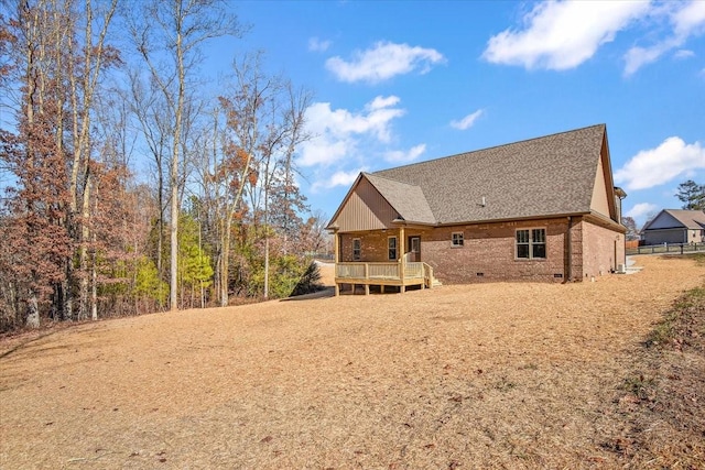 rear view of property with a wooden deck