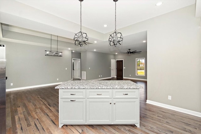 kitchen featuring white cabinets, dark hardwood / wood-style floors, ceiling fan, and hanging light fixtures