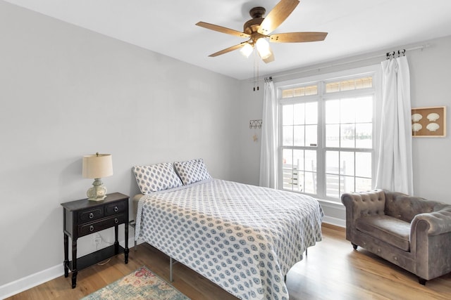 bedroom featuring light hardwood / wood-style flooring and ceiling fan