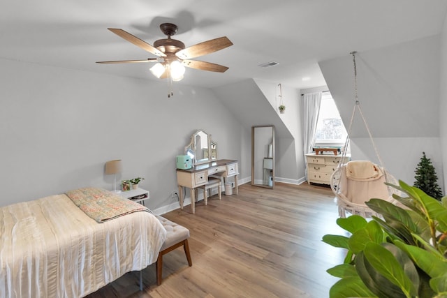 bedroom featuring wood-type flooring, vaulted ceiling, and ceiling fan