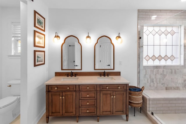 bathroom featuring tile patterned flooring, vanity, toilet, and a shower with door