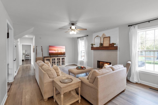 living room with light wood-type flooring and ceiling fan