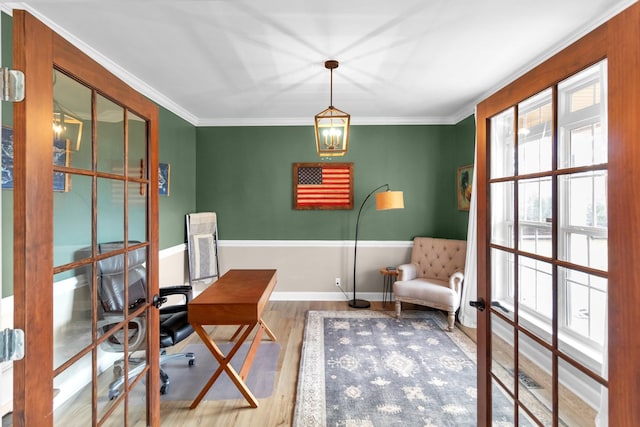 office with wood-type flooring, crown molding, and french doors