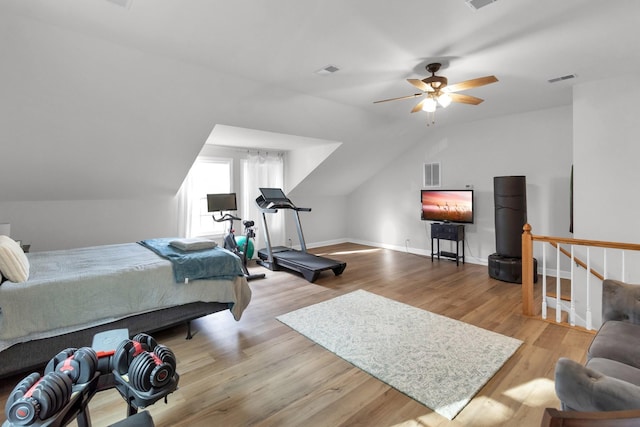 bedroom with ceiling fan, light hardwood / wood-style floors, and lofted ceiling