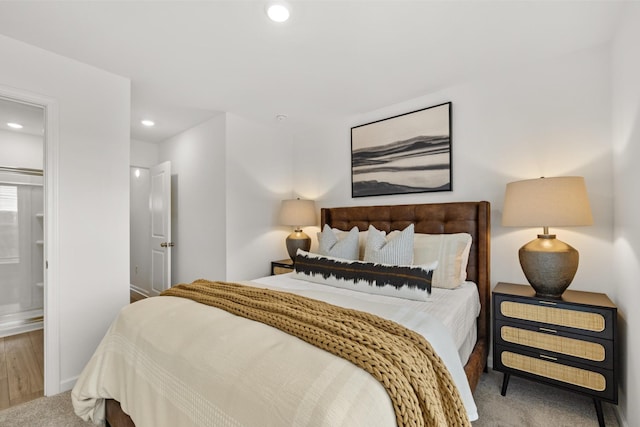 bedroom with carpet flooring and ensuite bath