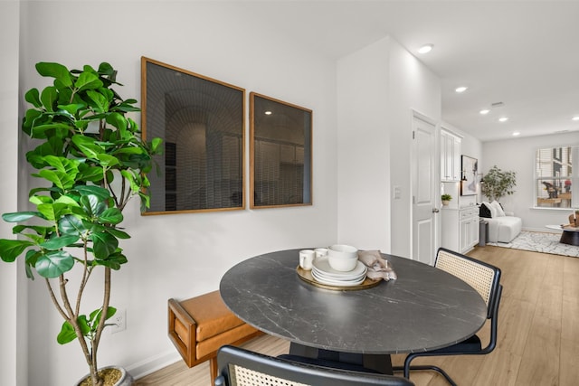 dining space featuring light wood-type flooring