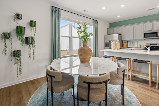 dining area featuring light hardwood / wood-style flooring and sink