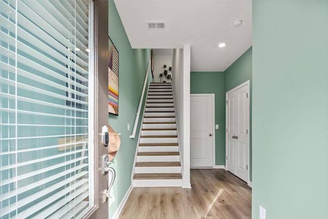 staircase with wood-type flooring