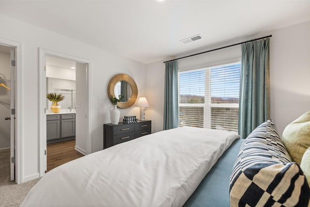 carpeted bedroom with ensuite bathroom