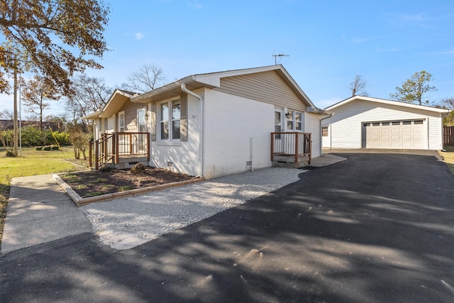 view of side of property featuring an outdoor structure and a garage