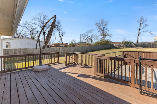 wooden deck featuring a yard