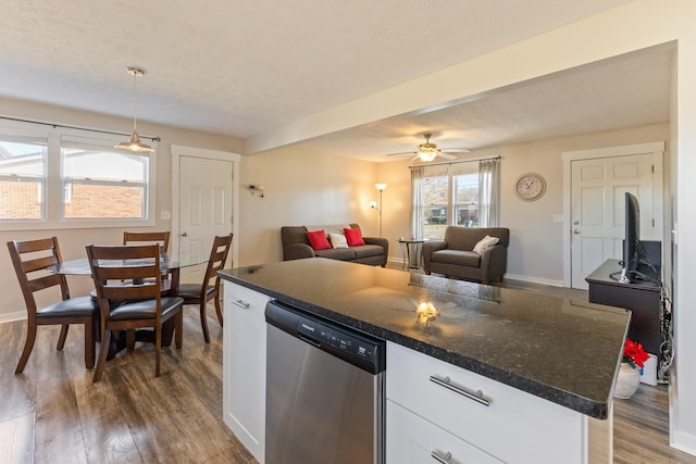 kitchen featuring white cabinetry, dishwasher, ceiling fan, pendant lighting, and wood-type flooring