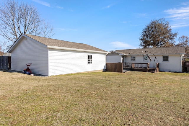 back of property featuring a lawn and a deck