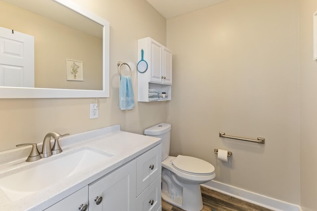 bathroom featuring wood-type flooring, vanity, and toilet