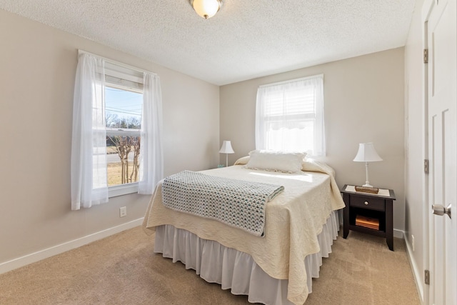 carpeted bedroom with multiple windows and a textured ceiling