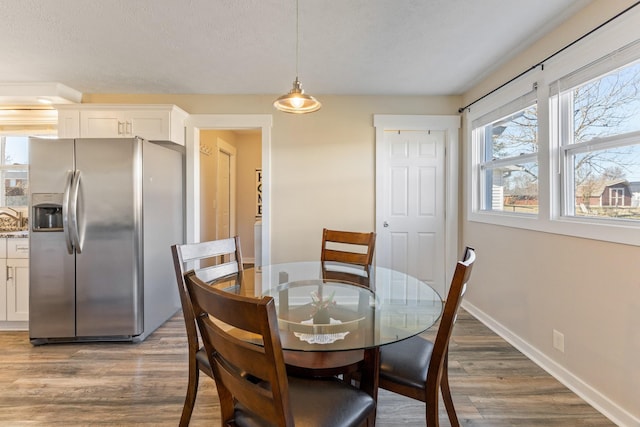 dining room featuring dark hardwood / wood-style flooring and a textured ceiling