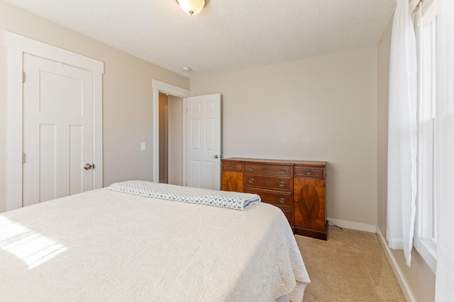 carpeted bedroom featuring a textured ceiling