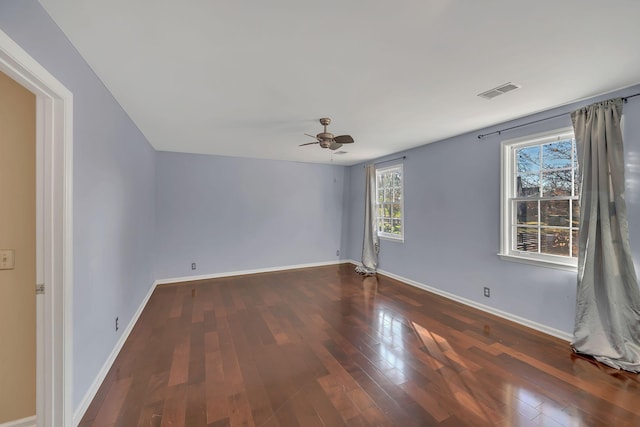 spare room featuring ceiling fan and dark wood-type flooring