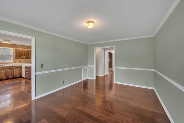 unfurnished room with dark hardwood / wood-style flooring, crown molding, and sink