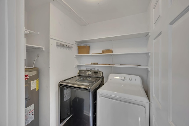 washroom featuring washing machine and dryer and water heater