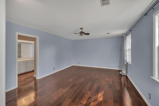 spare room featuring dark hardwood / wood-style flooring and ceiling fan